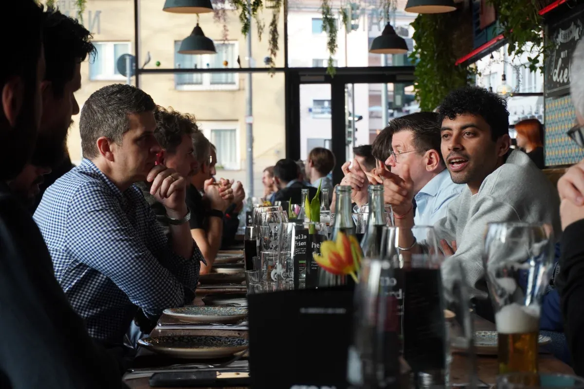 Members talking across a long dinner table